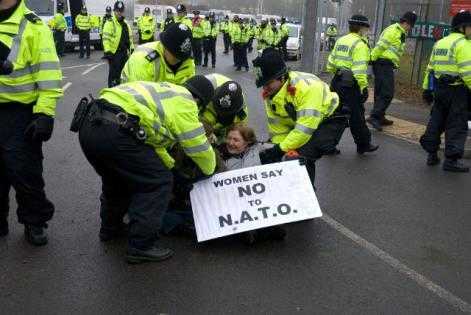 15 February 2010: Blockade at AWE Aldermaston in Britain. Nobel Peace Prize winner Mairead Maguire being removed from the blockade by police. Photo: Cynthia Cockburn