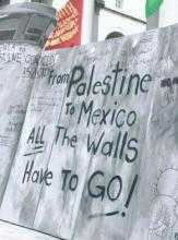 A banner reading "From Palestine to Mexico, all the walls have to go!"