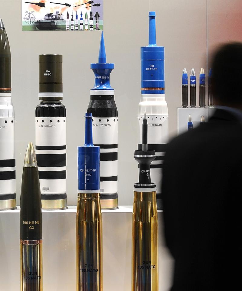 A man looks at a large range of missiles at the DSEI arms fair.