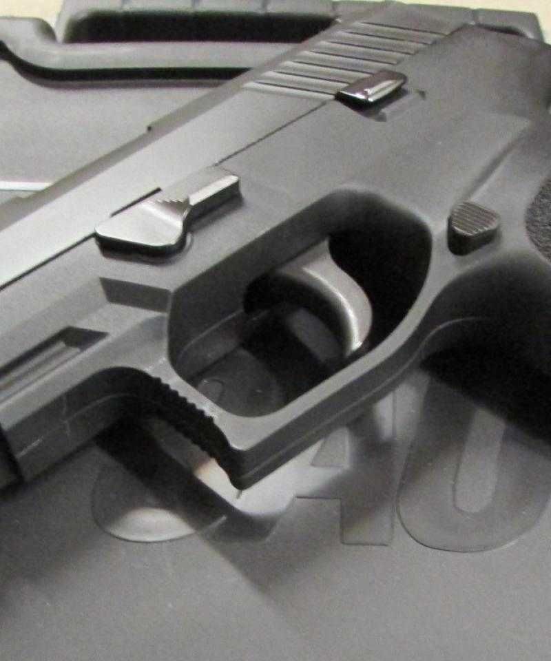 A Sig Sauer P320 pistol sat on a box