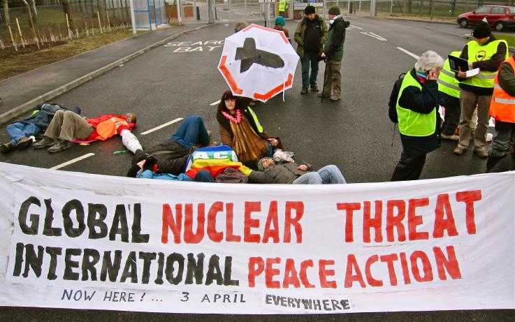 A blockade at a nuclear weapons factory, with a big banner