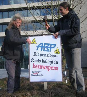 Two campaigners put up an anti-nuclear sign outside the APB offices in Netherlands