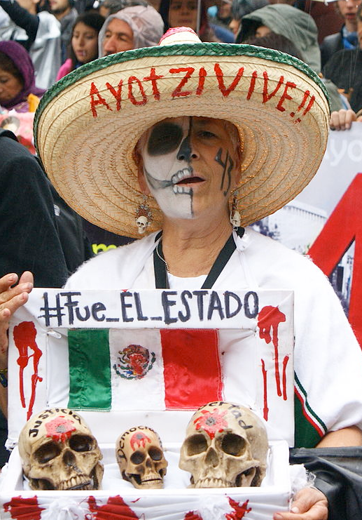 A woman in Mexico protests on the anniversary of the disappearance of 43 students in Mexico