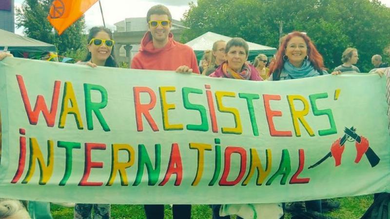WRI members behind our banner at the festival of resistance against DSEI!