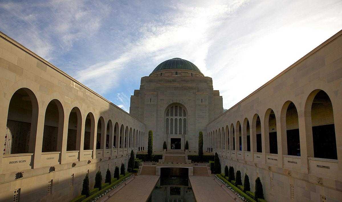 The Australian war memorial - a large stone building with arches and a central grass space