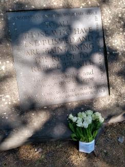 flowers laid in conscientious objectors' memorial stone in london