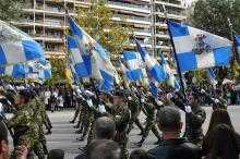 Greek soldiers marching with blue and white flags