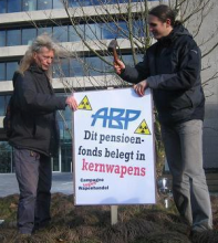Two campaigners put up an anti-nuclear sign outside the APB offices in Netherlands