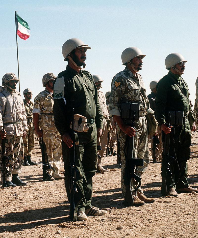  Kuwaiti soldiers stand in formation as a dignitary visits their outpost during Operation Desert Shield.