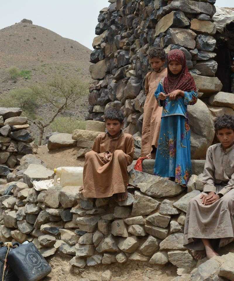 Children in Yemen standing outside the house