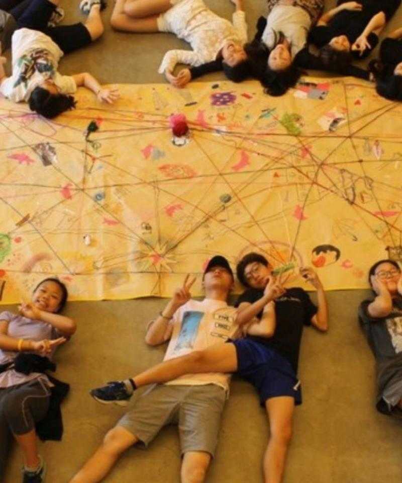 People lying in a circle on the floor