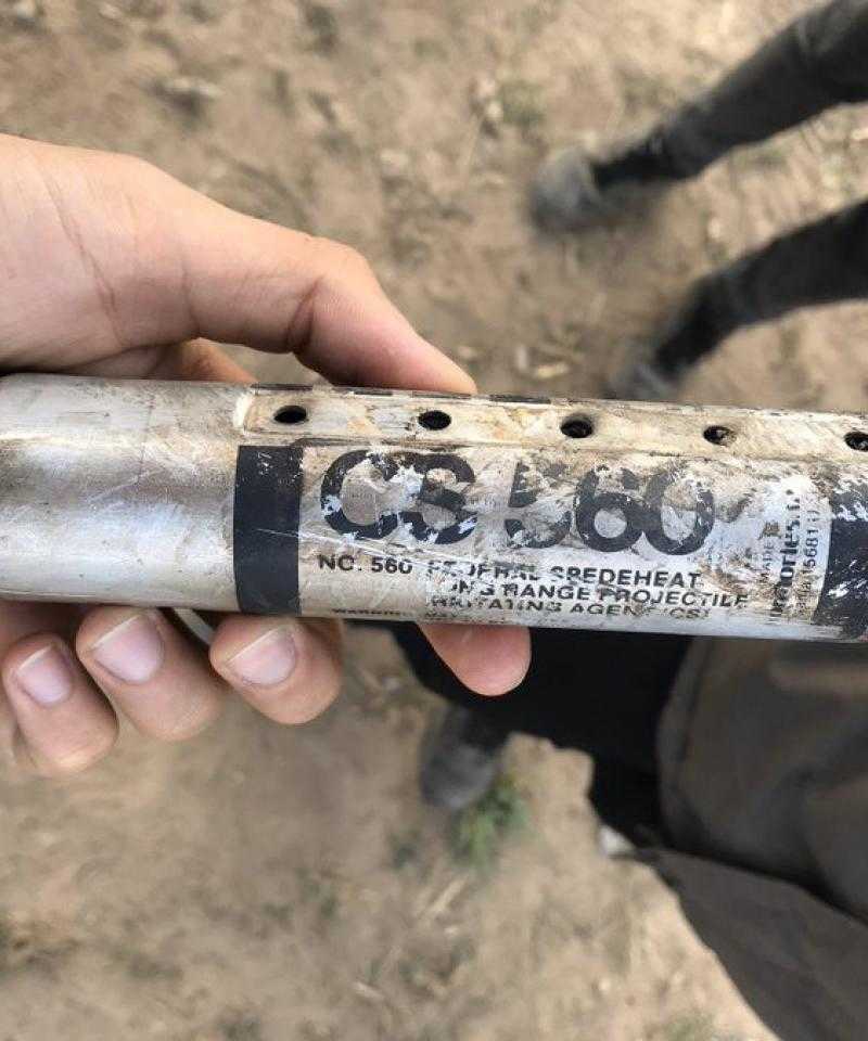 A large pointed tear gas canister labelled CS 560.