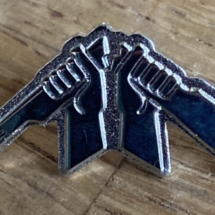 A WRI Broken Rifle pin badge.