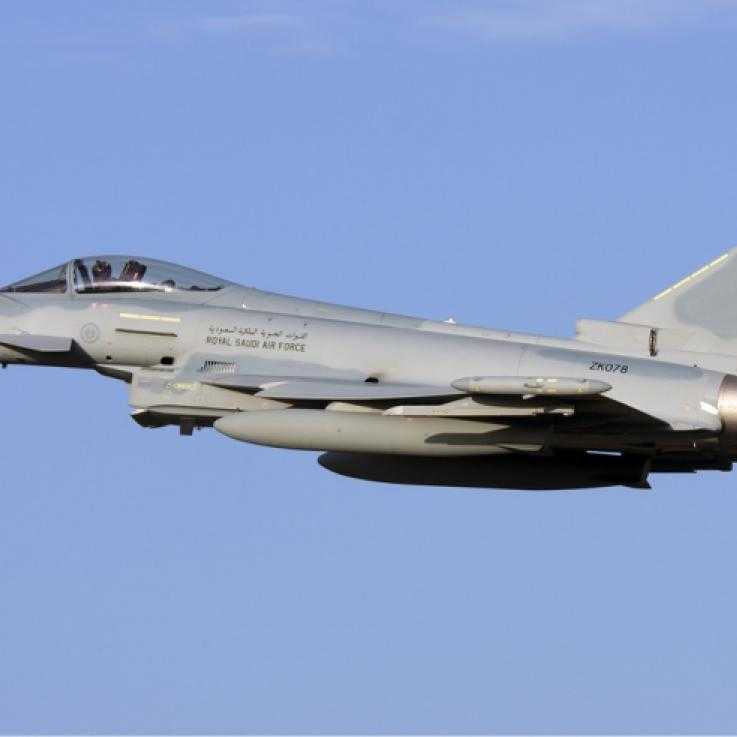 A eurofighter typhoon aircraft flying against a blue sky