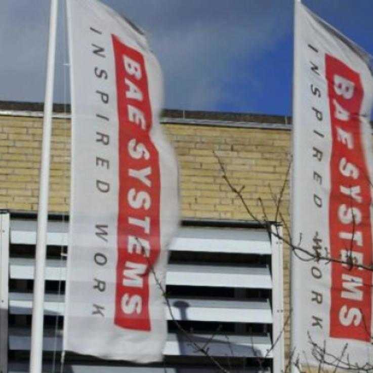 A BAE Systems office. Two flags with the BAE Systems logo fly outside.